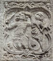 Panel 14:07 - Man/basilisk hybrid with sword, fighting peasant with club